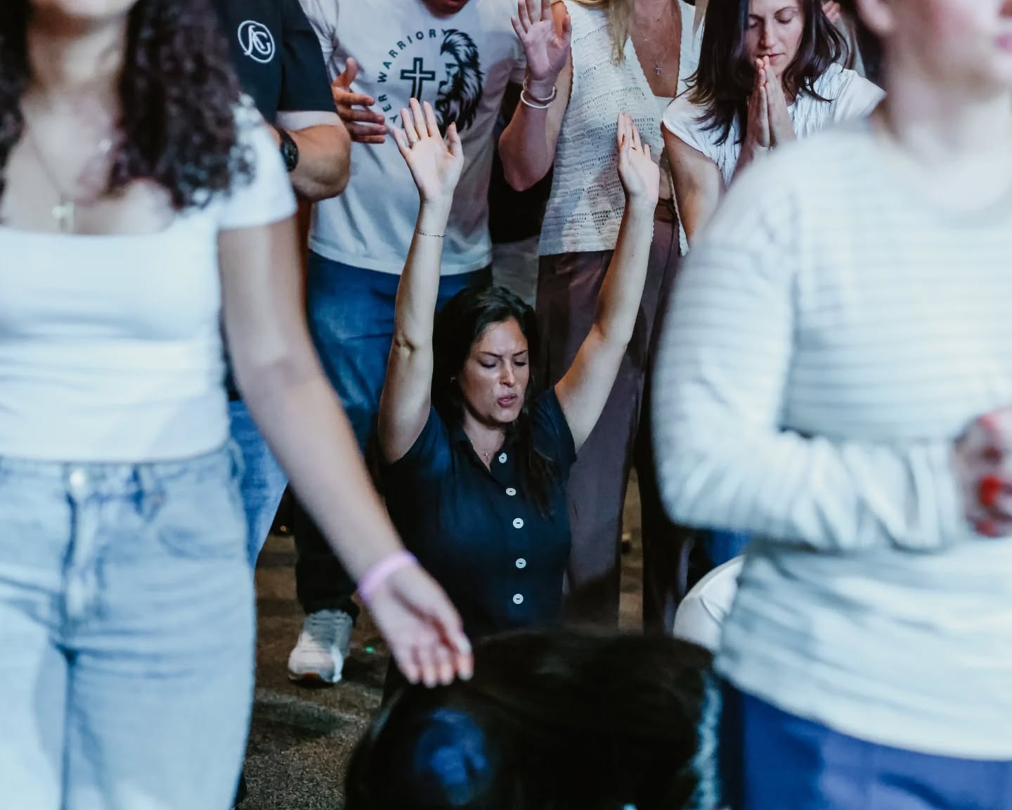 Families gathered in prayer at To·Gather