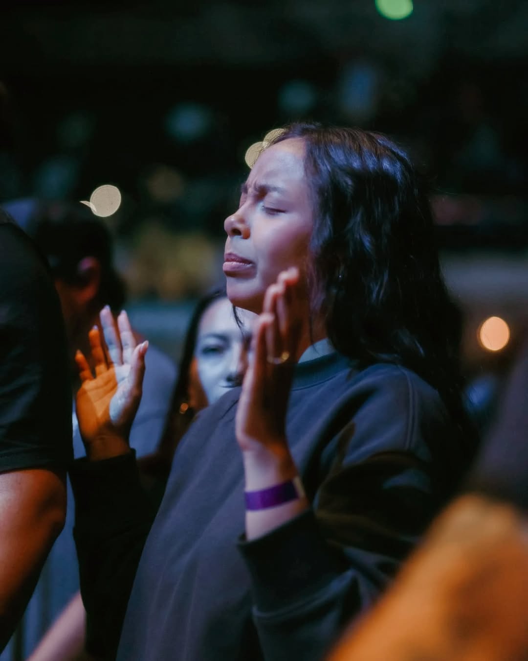 Woman worshipping at To·Gather