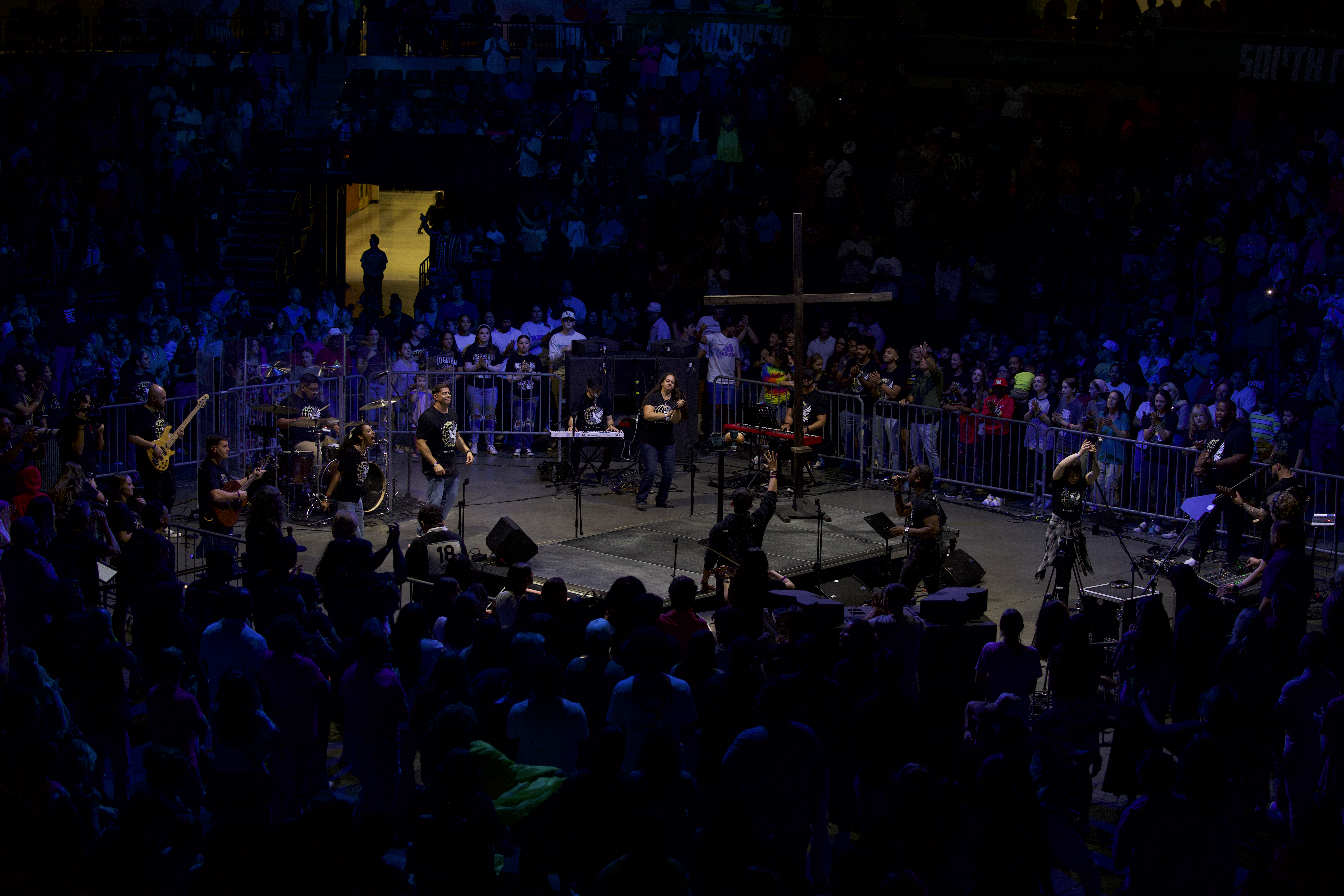 Worship band on stage with cross at Yuengling Center